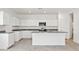 Modern kitchen featuring white cabinets, granite countertops, and stainless steel appliances at 22540 N Lynn St, Maricopa, AZ 85138