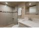 Modern bathroom with tiled shower, patterned accent, and quartz countertop sink at 2320 S Forest Ave, Tempe, AZ 85282