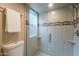 Glass enclosed shower features modern tilework, and a built-in shower seat at 2320 S Forest Ave, Tempe, AZ 85282
