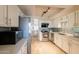 Modern kitchen equipped with stainless steel appliances, white cabinets, and a stylish backsplash at 2320 S Forest Ave, Tempe, AZ 85282