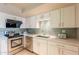 Bright kitchen features stainless steel appliances, subway tile backsplash, and ample cabinet space at 2320 S Forest Ave, Tempe, AZ 85282