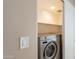A laundry closet features a modern washer and dryer, with shelf above at 2320 S Forest Ave, Tempe, AZ 85282