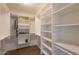 Walk-in closet features an abundance of shelving and room for storage at 2320 S Forest Ave, Tempe, AZ 85282