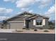 Charming single-story home featuring a two-car garage, neutral paint, and decorative stone accents at 24113 W Bowker St, Buckeye, AZ 85326