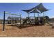 Community playground featuring swings, slides and covered play structure for residents to enjoy in a Gathering-friendly neighborhood at 24113 W Bowker St, Buckeye, AZ 85326