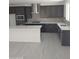Modern kitchen featuring stainless steel appliances, dark cabinetry, and a white center island at 2463 W Rowel Rd, Phoenix, AZ 85085