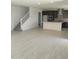 Bright open-concept living area with wood floors, flowing into a modern kitchen with a large island at 2463 W Rowel Rd, Phoenix, AZ 85085