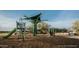 Outdoor community playground with climbing structures, slide and shade, surrounded by wood chip ground cover at 2463 W Rowel Rd, Phoenix, AZ 85085