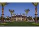 Grand community clubhouse surrounded by manicured landscaping and tall palm trees creating an opulent ambiance at 2480 W Rowel Rd, Phoenix, AZ 85085
