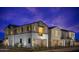 Modern two-story home exterior with gray and white paint, a balcony, and a visible garage at twilight at 2480 W Rowel Rd, Phoenix, AZ 85085