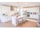 Bright, modern kitchen featuring white cabinetry, stainless steel appliances, and center island with seating at 2480 W Rowel Rd, Phoenix, AZ 85085