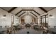 Elegant meeting room with round tables, wooden chairs, exposed beams and a chandelier at 2480 W Rowel Rd, Phoenix, AZ 85085