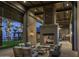Inviting outdoor lounge with a stone fireplace, comfortable seating, and palm tree views at 2480 W Rowel Rd, Phoenix, AZ 85085