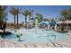 Community splash pad with various water features, surrounded by lounge seating and palm trees at 2480 W Rowel Rd, Phoenix, AZ 85085