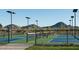 Community tennis courts featuring blue and green surfaces, black fencing, and mountain views in the background at 2480 W Rowel Rd, Phoenix, AZ 85085