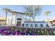 Welcome to Norterra! View of retail shopping area at community entrance with colorful flowers and palm trees at 2484 W Rowel Rd, Phoenix, AZ 85085
