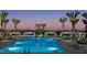 Stunning resort-style pool area with cabanas, lounge chairs, and lush landscaping at twilight at 2484 W Rowel Rd, Phoenix, AZ 85085