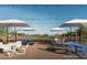 Outdoor basketball court with shaded seating areas and stylish tables under a clear blue sky at 2486 W Rowel Rd, Phoenix, AZ 85085