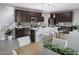 A modern kitchen with dark cabinets, a center island, and stainless steel appliances at 2486 W Rowel Rd, Phoenix, AZ 85085