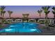 Inviting community pool lined with palm trees and shaded cabanas at 2486 W Rowel Rd, Phoenix, AZ 85085