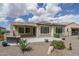 Backyard showing desert landscaping, concrete patio, and covered veranda with attached home at 26017 W Maple Dr, Buckeye, AZ 85396