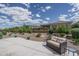 Landscaped backyard with desert plants, gravel, block wall fence, and outdoor sofa at 26017 W Maple Dr, Buckeye, AZ 85396