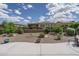 Backyard featuring desert landscaping, including small shrubs, plants, and rock ground cover at 26017 W Maple Dr, Buckeye, AZ 85396
