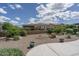 Landscaped backyard featuring desert plants, rock ground cover, and block wall fence at 26017 W Maple Dr, Buckeye, AZ 85396