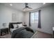 Stylishly furnished bedroom with modern decor, plush bedding, and a bright window view at 26017 W Maple Dr, Buckeye, AZ 85396