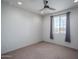 Bedroom featuring a ceiling fan, window, and neutral decor at 26017 W Maple Dr, Buckeye, AZ 85396