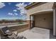 Inviting covered patio with cozy seating, providing a perfect spot for outdoor relaxation and enjoying neighborhood views at 26017 W Maple Dr, Buckeye, AZ 85396