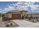 Beautiful single-story home with a well-maintained lawn, inviting curb appeal, and a spacious two car garage at 26017 W Maple Dr, Buckeye, AZ 85396