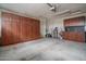 Spacious garage with lots of storage cabinets and utility sink at 26017 W Maple Dr, Buckeye, AZ 85396