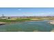 A beautifully manicured golf course with a serene pond is a highlight of this well-maintained community at 26017 W Maple Dr, Buckeye, AZ 85396