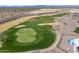 An aerial view of the lush green golf course and surrounding desert landscape is a great feature of this community at 26017 W Maple Dr, Buckeye, AZ 85396