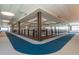 Well-lit hallway with large windows offering scenic views and a modern design, perfect for a comfortable walk at 26017 W Maple Dr, Buckeye, AZ 85396