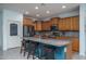 Spacious kitchen featuring a large granite island, modern appliances, and ample counter space at 26017 W Maple Dr, Buckeye, AZ 85396