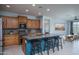 Well-equipped kitchen featuring a large island with bar seating and sleek stainless steel appliances at 26017 W Maple Dr, Buckeye, AZ 85396