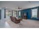 Comfortable living room with plush seating, modern entertainment setup, and large windows for natural light at 26017 W Maple Dr, Buckeye, AZ 85396