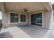 Covered patio with large windows and sliding door offering views of the backyard at 26017 W Maple Dr, Buckeye, AZ 85396