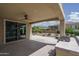 Covered patio with ceiling fan provides the perfect location to enjoy the backyard at 26017 W Maple Dr, Buckeye, AZ 85396