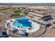 Aerial view of the community pool and clubhouse offering ample seating and luxurious amenities at 26017 W Maple Dr, Buckeye, AZ 85396