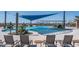 Resort-style community pool with ample lounge chairs, inviting water features, and shaded seating areas at 26017 W Maple Dr, Buckeye, AZ 85396
