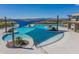 Stunning community pool area showcasing a relaxing swim spot with ample deck space, umbrellas, and mountain views at 26017 W Maple Dr, Buckeye, AZ 85396
