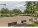 The shuffleboard courts in the community are set amongst mature trees and manicured grounds at 26017 W Maple Dr, Buckeye, AZ 85396