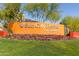Sun City Festival signage showcasing bright flowers, manicured green grass and clear blue skies at 26017 W Maple Dr, Buckeye, AZ 85396