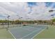 Several well-maintained community tennis courts are nestled within a desert landscape, offering a sporty lifestyle at 26017 W Maple Dr, Buckeye, AZ 85396
