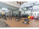 Modern weight room featuring a variety of free weights, weight machines, and large mirrors for form correction at 26017 W Maple Dr, Buckeye, AZ 85396