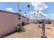 Exterior shot of backyard showcasing desert landscaping and palm trees at 2700 E Allred Ave # R87, Mesa, AZ 85204