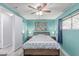 Bedroom with wood-look floors, teal accent wall and ceiling fan at 2700 E Allred Ave # R87, Mesa, AZ 85204